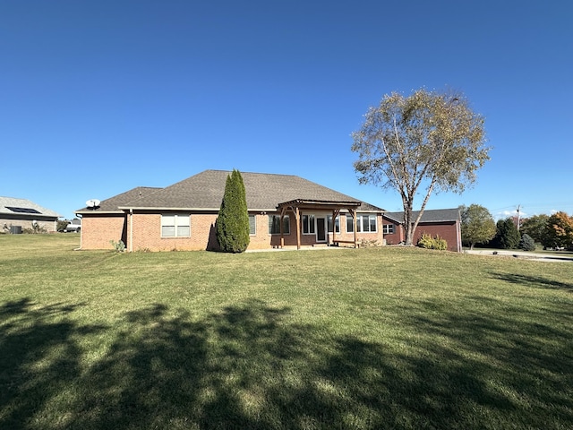 rear view of property with a yard