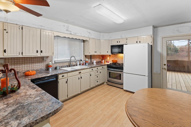 kitchen featuring sink, tasteful backsplash, light hardwood / wood-style floors, and black appliances