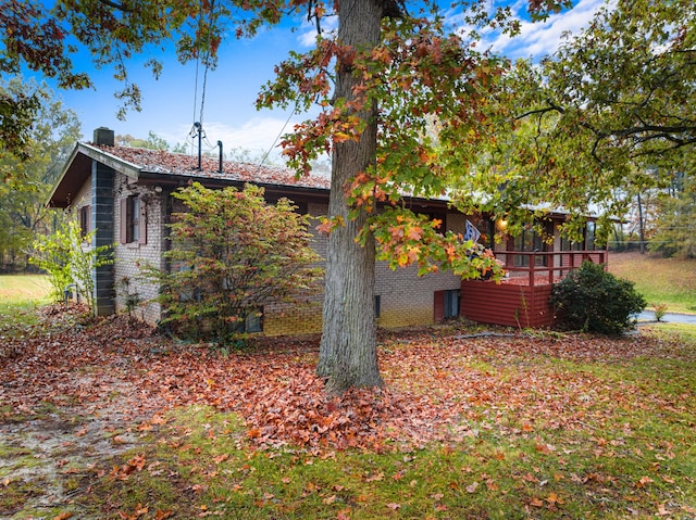 view of side of home featuring a wooden deck