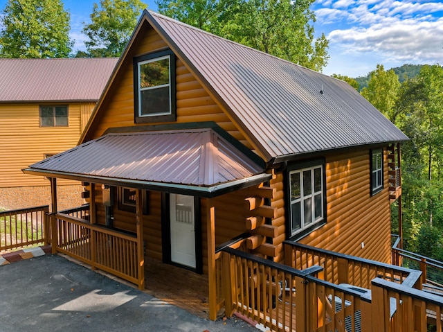 log home featuring covered porch