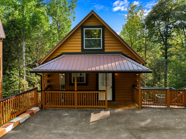 log home featuring a porch