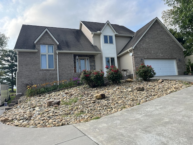 219 Sullivan Pt, Dandridge, TN 37725 - traditional home with asphalt driveway, brick siding, a garage, and roof with shingles