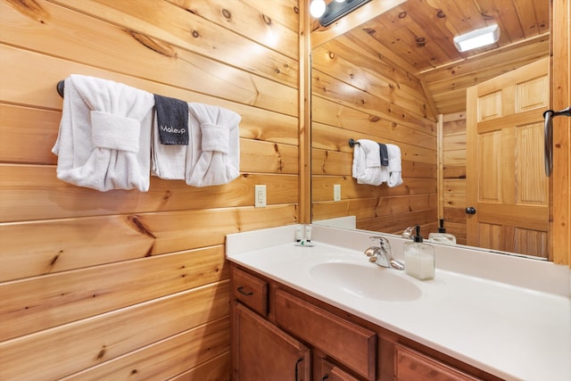 bathroom featuring vanity, wood ceiling, and wooden walls