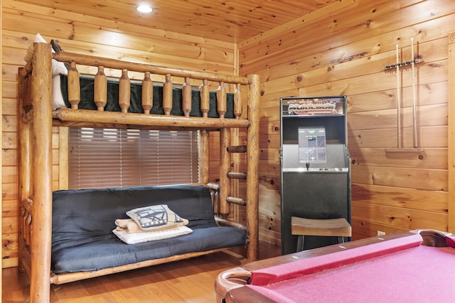 unfurnished bedroom with wood ceiling, hardwood / wood-style flooring, and wooden walls