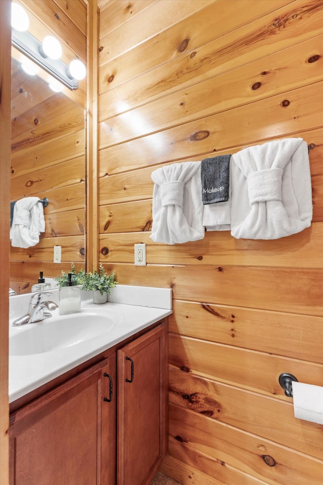 bathroom with vanity and wooden walls