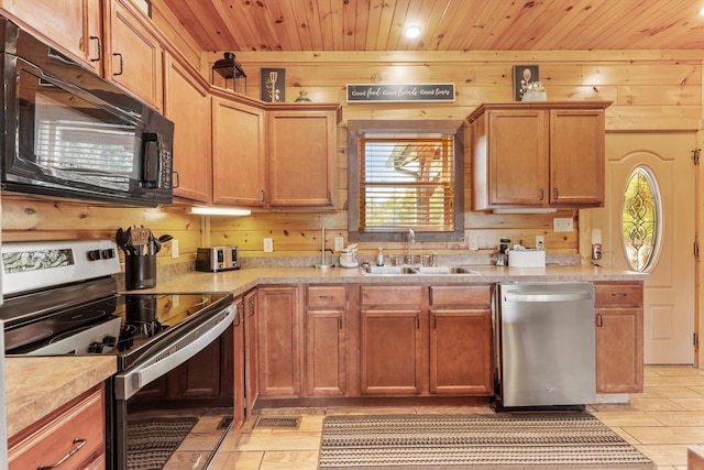 kitchen with appliances with stainless steel finishes, wooden walls, sink, and wooden ceiling