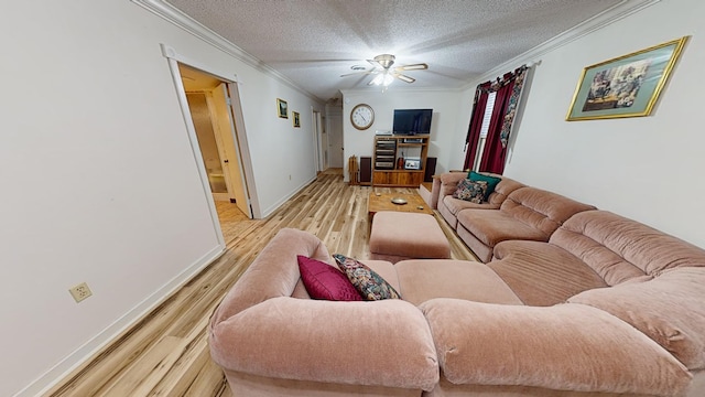 living room featuring ceiling fan, ornamental molding, a textured ceiling, and light hardwood / wood-style flooring