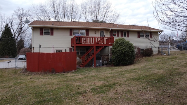 back of property with a wooden deck, central AC, and a lawn