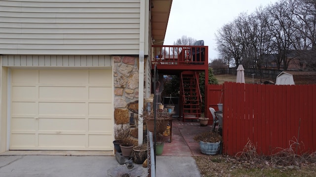 view of property exterior with a garage and a wooden deck