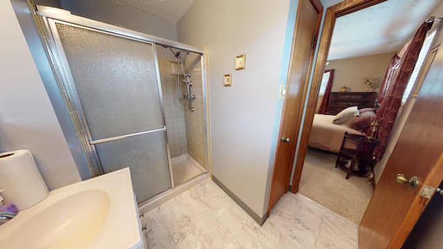 bathroom featuring a textured ceiling and a shower with shower door