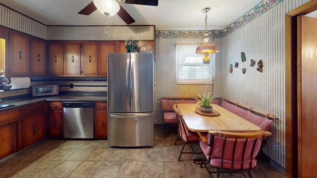 kitchen featuring appliances with stainless steel finishes, ceiling fan, and decorative light fixtures