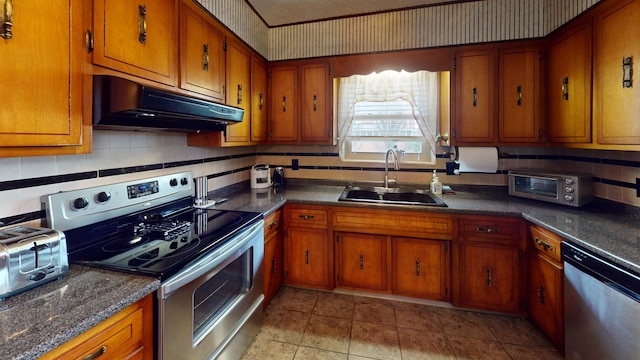 kitchen featuring sink, backsplash, stainless steel appliances, and light tile patterned floors