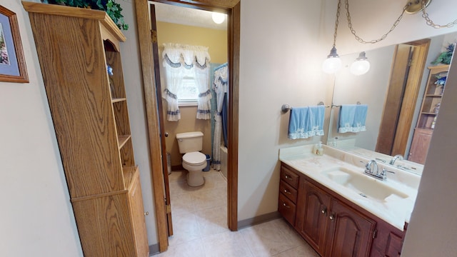 bathroom with vanity, tile patterned flooring, and toilet