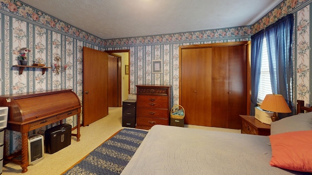 bedroom featuring light colored carpet and a textured ceiling