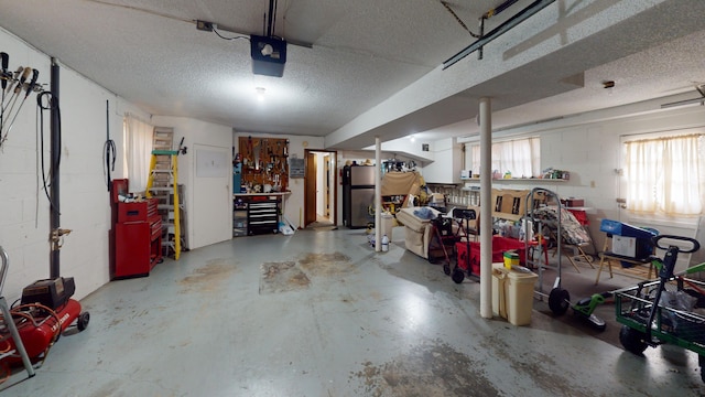 garage featuring a garage door opener and refrigerator