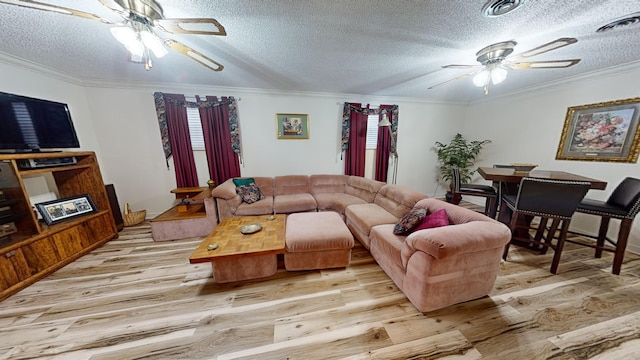 living room with crown molding, ceiling fan, and light hardwood / wood-style flooring