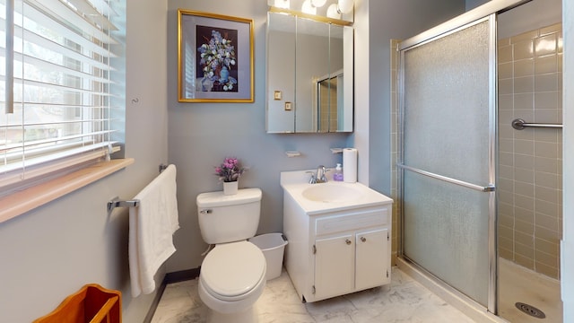 bathroom with vanity, toilet, and a shower with shower door