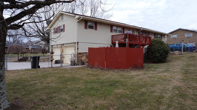 back of house featuring a garage and a yard