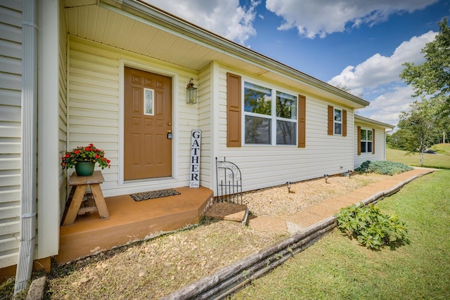 doorway to property with a yard