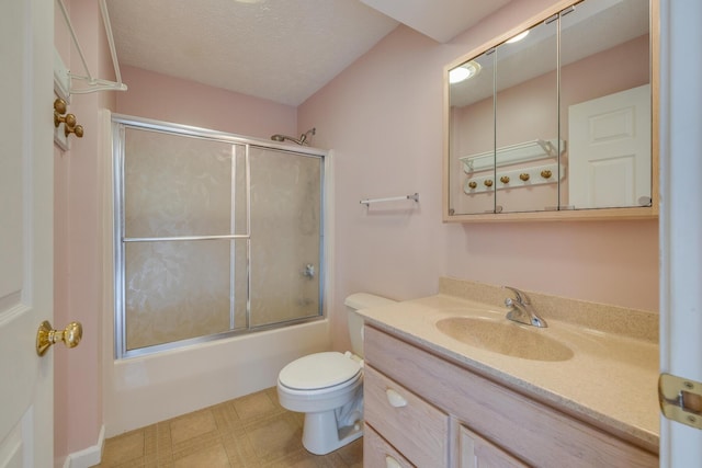 full bathroom with vanity, a textured ceiling, shower / bath combination with glass door, and toilet