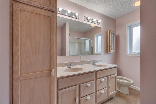 bathroom with a healthy amount of sunlight, an enclosed shower, a textured ceiling, and toilet