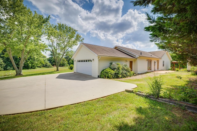 ranch-style home featuring a garage and a front lawn