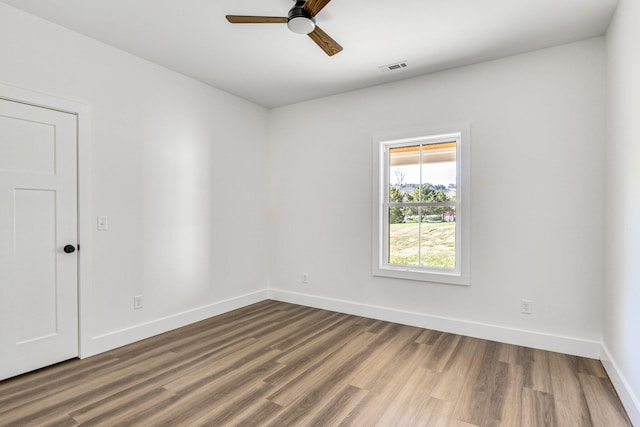 empty room featuring wood-type flooring and ceiling fan