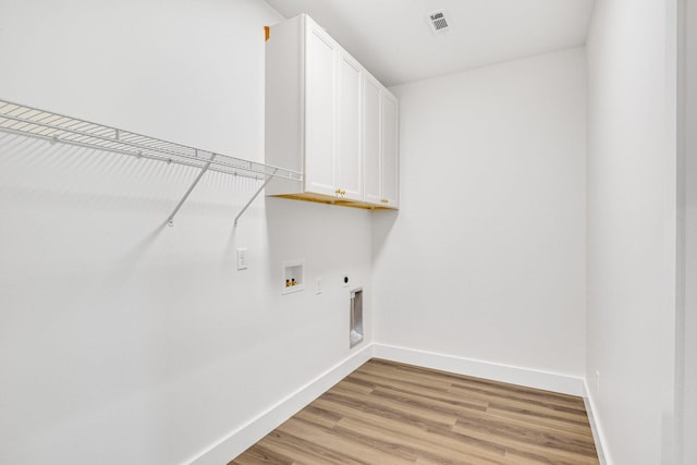 washroom with hookup for a washing machine, light hardwood / wood-style flooring, cabinets, and hookup for an electric dryer