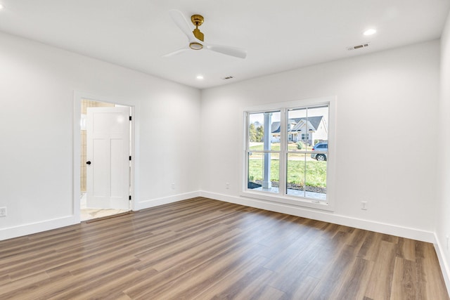 unfurnished room with dark hardwood / wood-style floors and ceiling fan