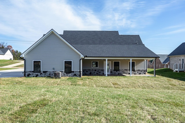 back of house featuring a lawn and cooling unit