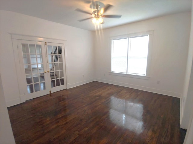 unfurnished room with dark hardwood / wood-style floors, ceiling fan, and french doors