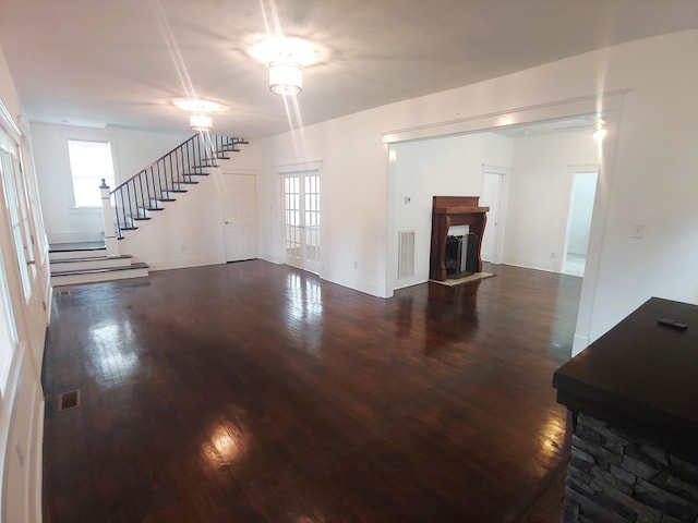 unfurnished living room with dark wood-type flooring