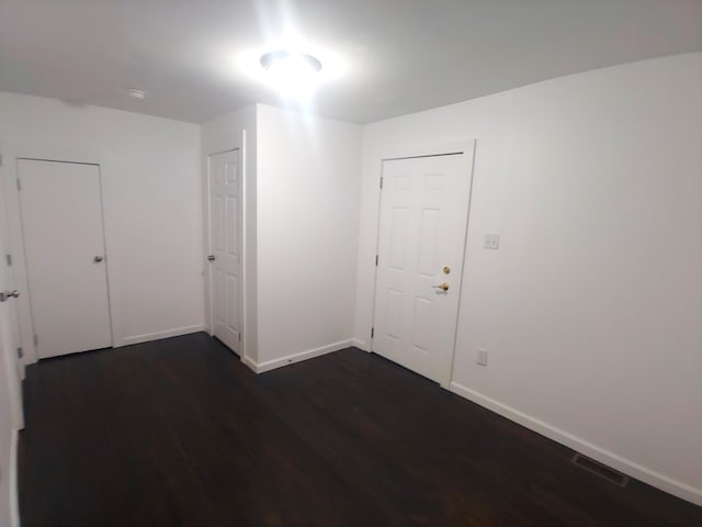 empty room featuring dark wood-type flooring