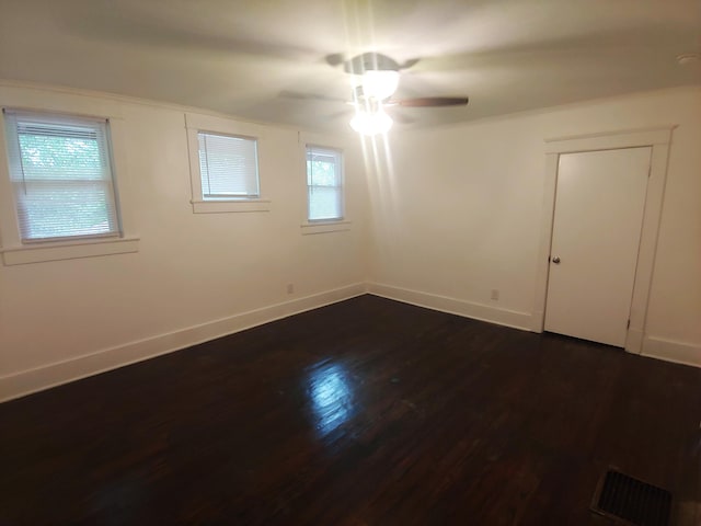 unfurnished room with dark hardwood / wood-style floors and ceiling fan