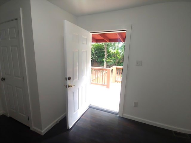 entryway with dark hardwood / wood-style flooring