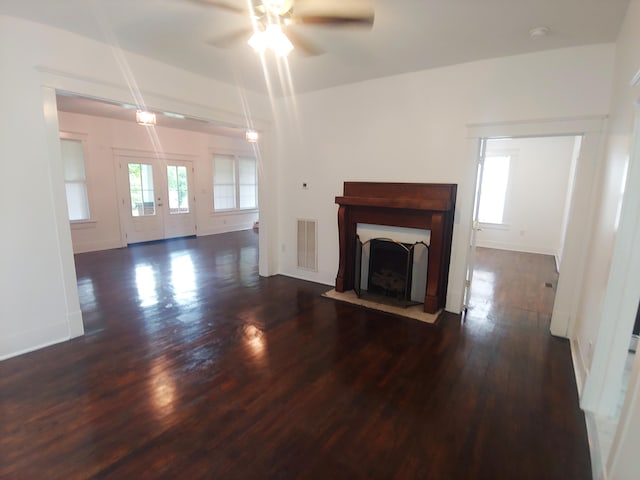 unfurnished living room with ceiling fan and dark hardwood / wood-style flooring