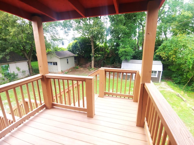 wooden terrace with a yard, an outbuilding, and a garage