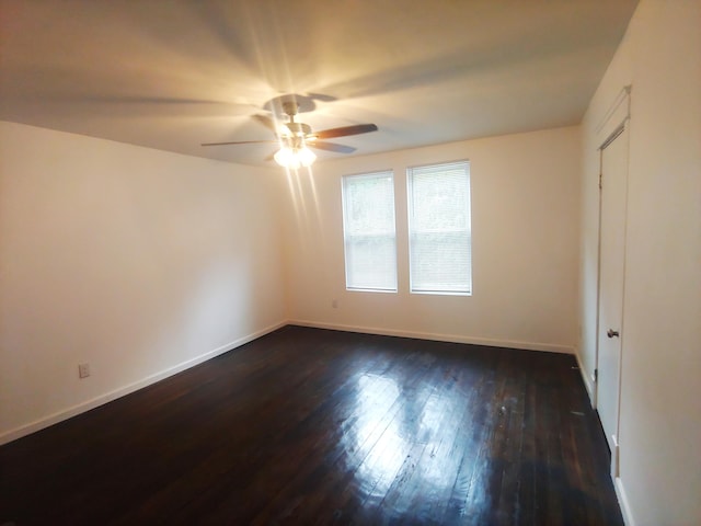 unfurnished bedroom featuring ceiling fan and dark hardwood / wood-style floors