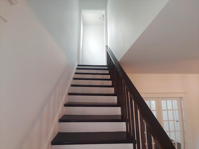 staircase with french doors