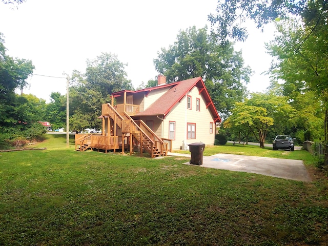 back of house featuring a patio area and a yard