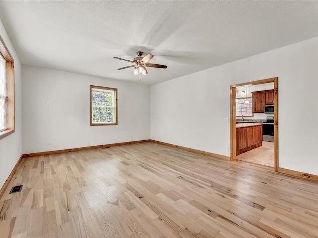 107 Straight Creek Dock Rd, New Tazewell, TN 37825 - unfurnished room with light wood-type flooring, ceiling fan, and baseboards