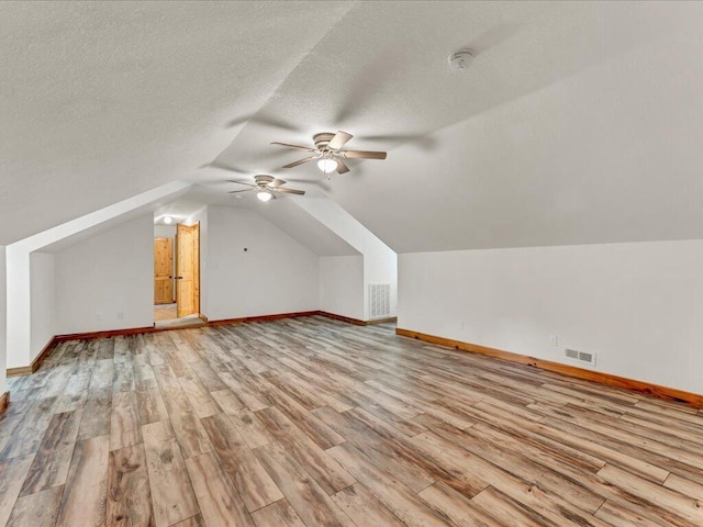 107 Straight Creek Dock Rd, New Tazewell, TN 37825 - additional living space with light wood-style floors, ceiling fan, baseboards, vaulted ceiling, and a textured ceiling