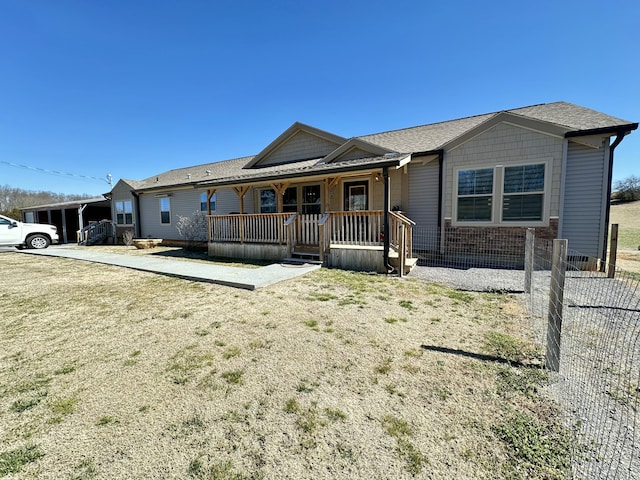 view of front of home featuring covered porch and brick siding