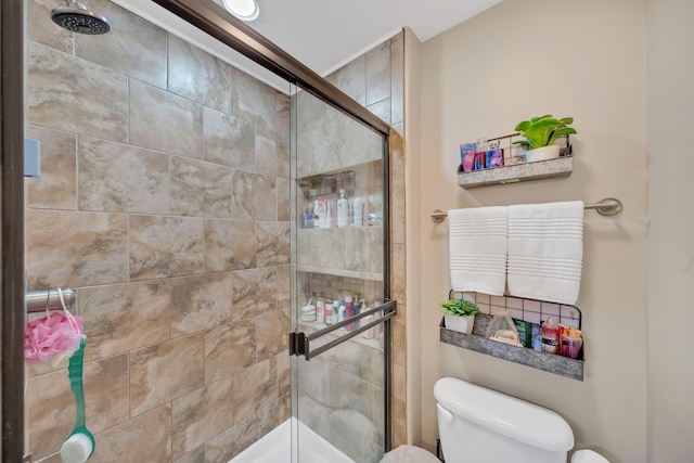 bathroom featuring an enclosed shower and toilet