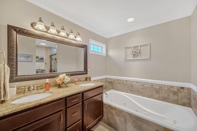 bathroom with tiled tub, crown molding, and vanity