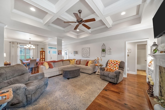 living room with ornamental molding, coffered ceiling, ceiling fan with notable chandelier, beamed ceiling, and hardwood / wood-style floors