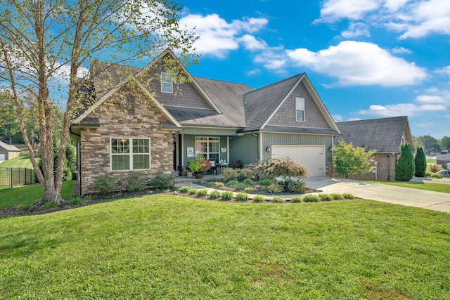 craftsman house featuring a front yard and a garage