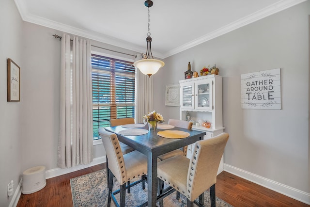 dining space with crown molding and dark hardwood / wood-style floors