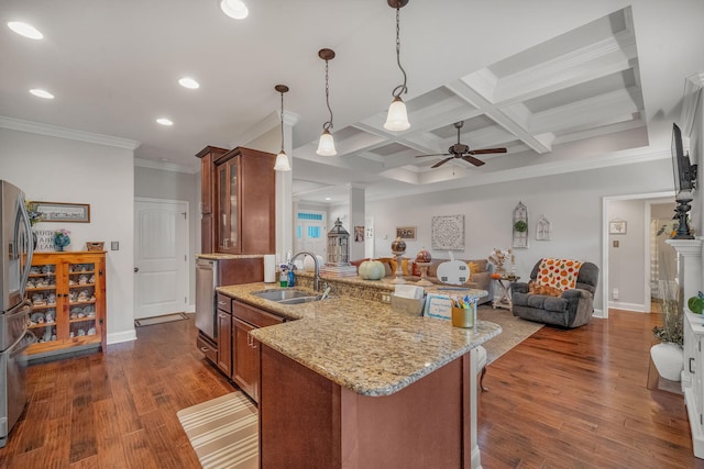 kitchen featuring ceiling fan, sink, hanging light fixtures, coffered ceiling, and beamed ceiling