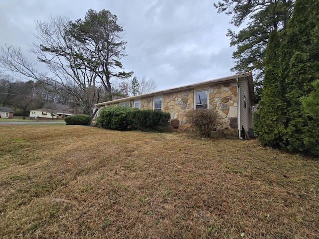 view of side of property with a lawn